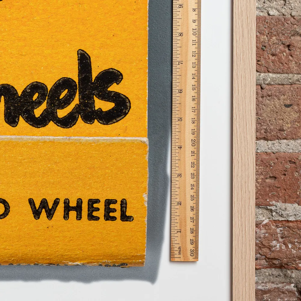 Chicago Wheel & Mfg. Co. matchbook next to a framed print, for scale