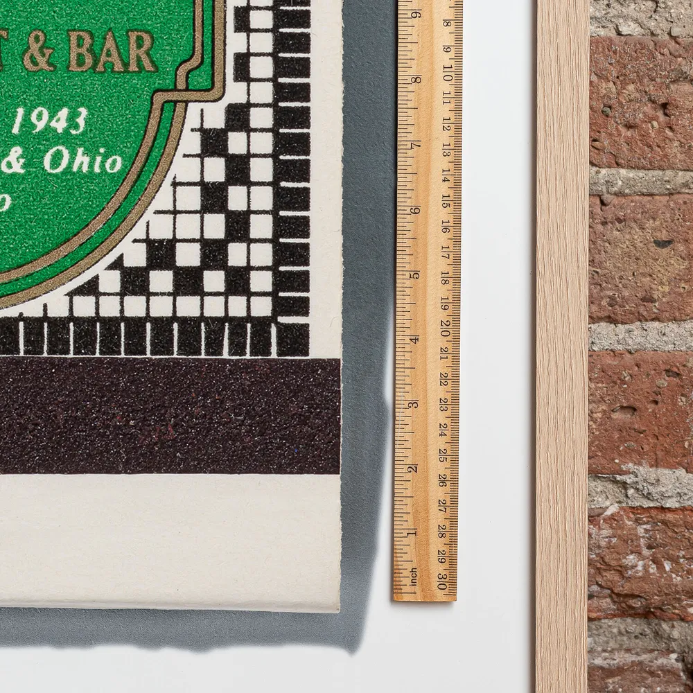 Pizzeria Uno matchbook next to a framed print, for scale
