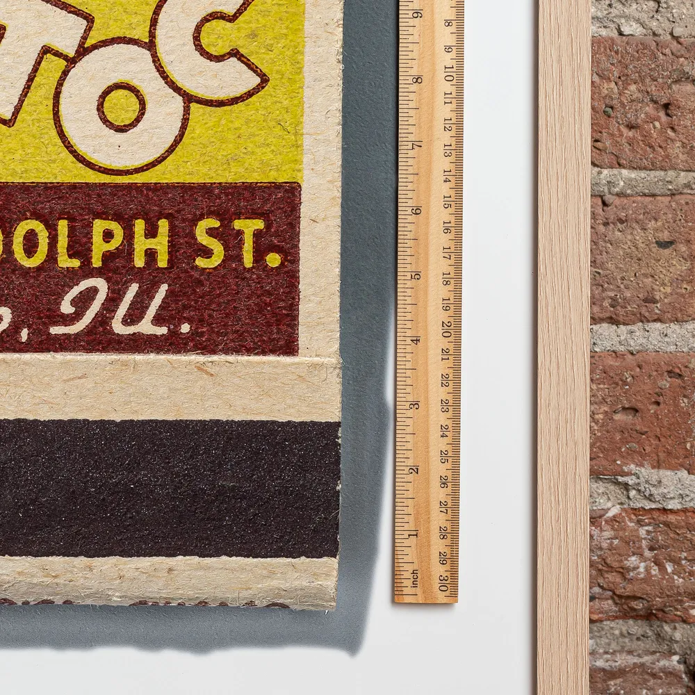 Tic Toc Lounge matchbook next to a framed print, for scale